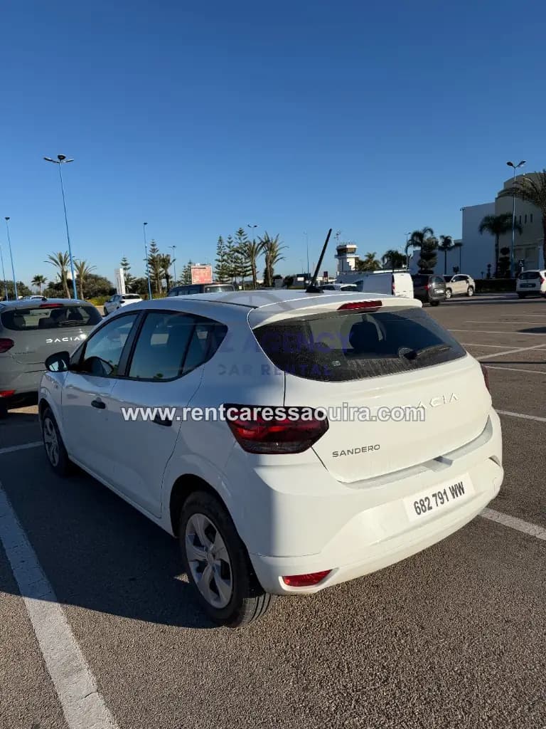 White Dacia Sandero rental Essaouira – rear view parking lot | Mz Agency