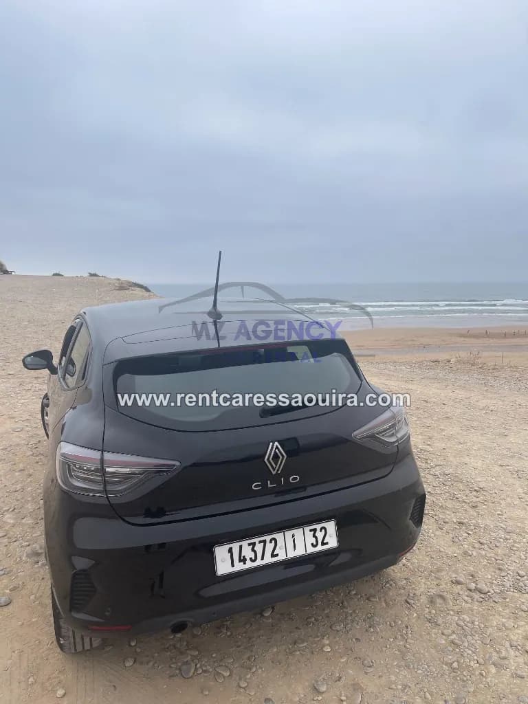 Clio 5 rental Essaouira – black car coastal cliffs Morocco | Mz Agency