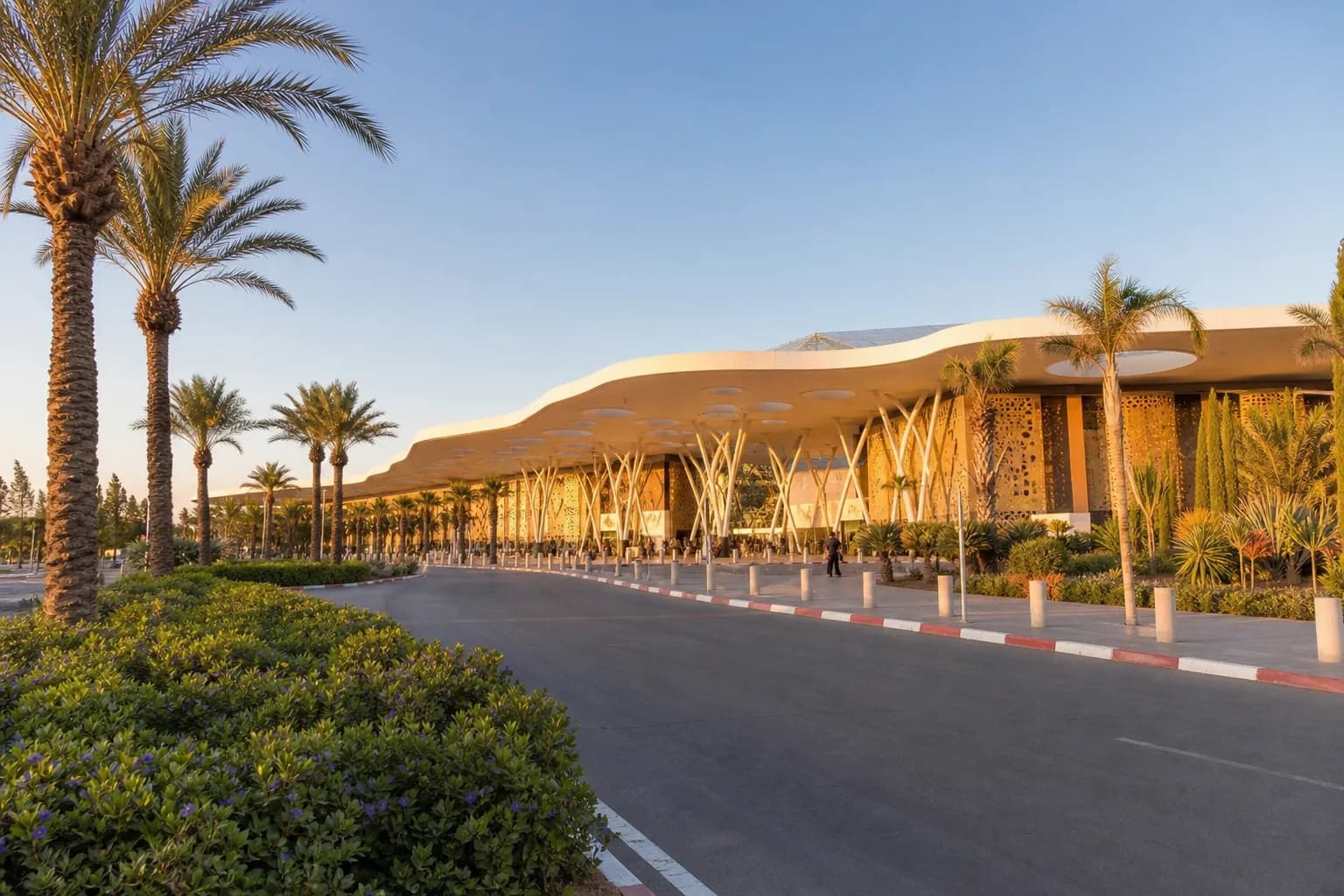 Palm-lined approach to Marrakech Menara Airport at golden hour